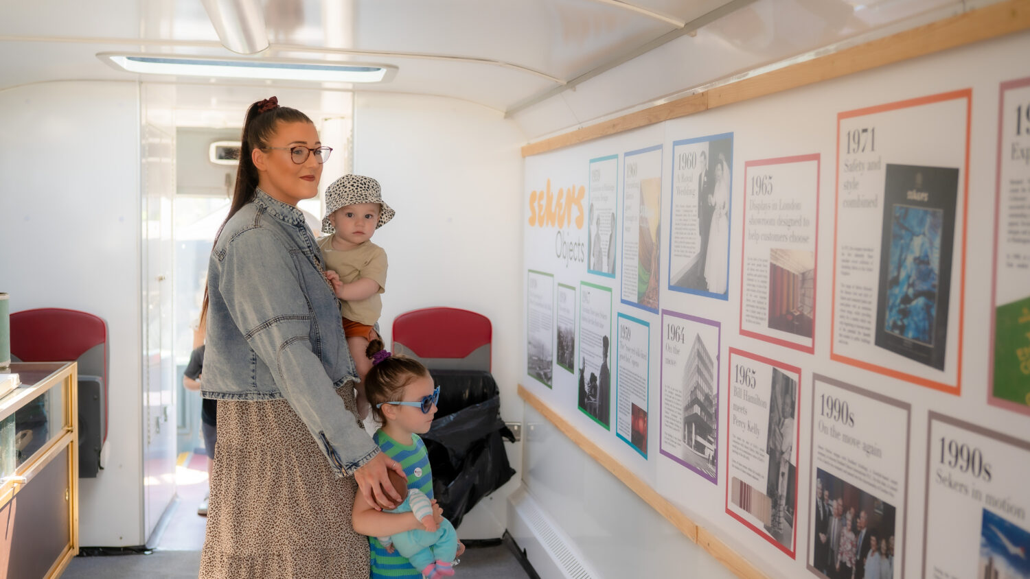 Mother and two small children looking at exhibition artwork